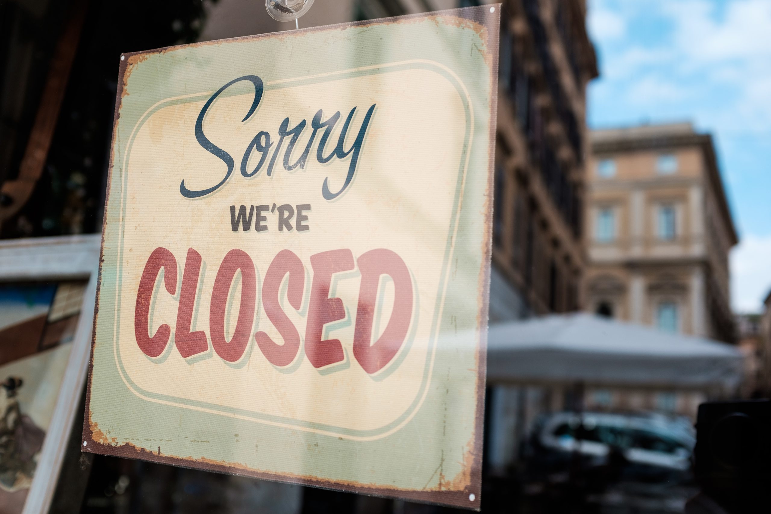 Sorry we're closed message board on a shop window, abandoned closed shut down cafe resta